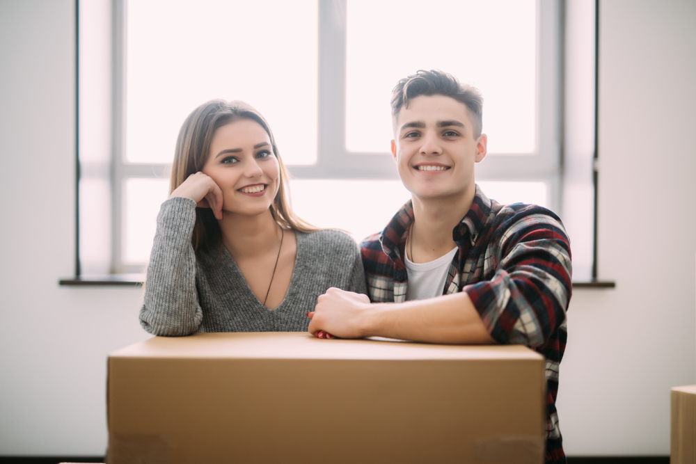 young couple with box - first home by durkan